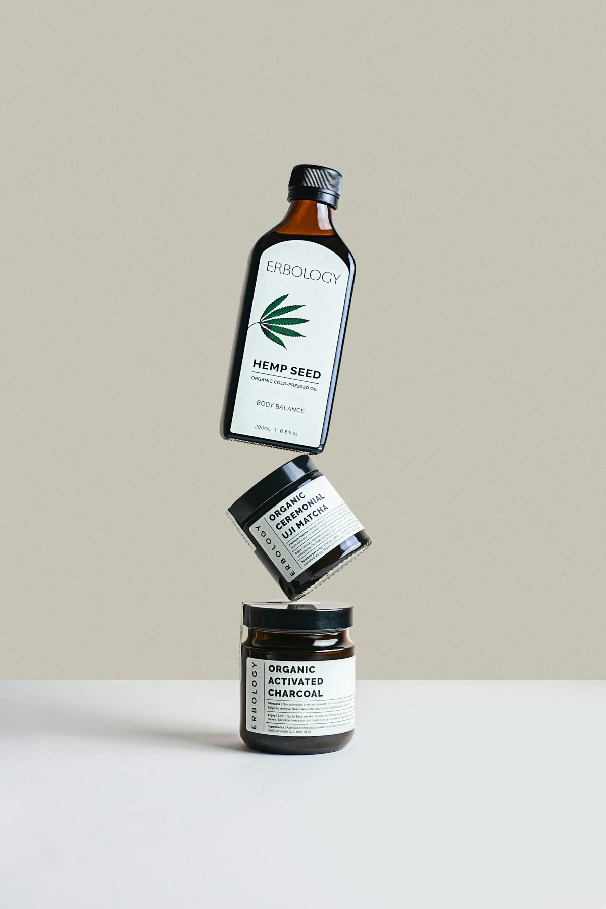 Botanical oil bottle and natural nutrition jars on a stone background